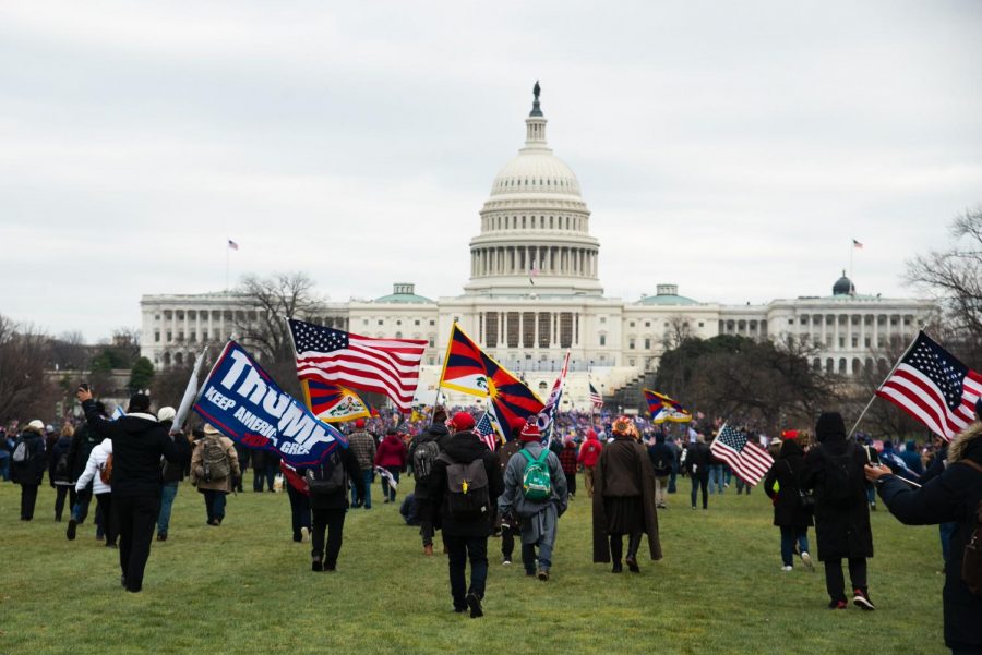 Rioters with flags march toward the Capitol Building early afternoon on Jan. 6. 