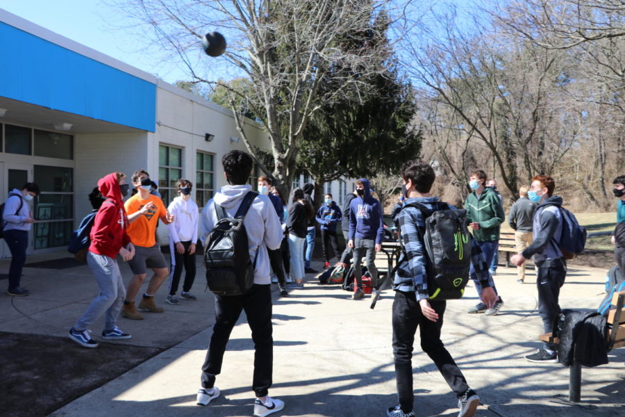 Students congregate outside during a break. Students are required to be outside during lunch and passing periods to avoid crowding the halls.