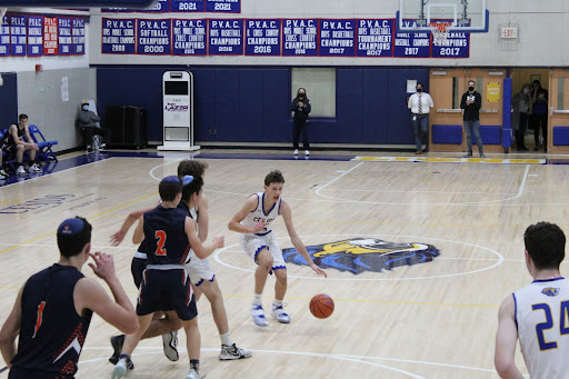 Junior forward David Fritz performs a hesitation move before attacking the basket. His 17 point outing led the team to a victory against their rival Berman. 