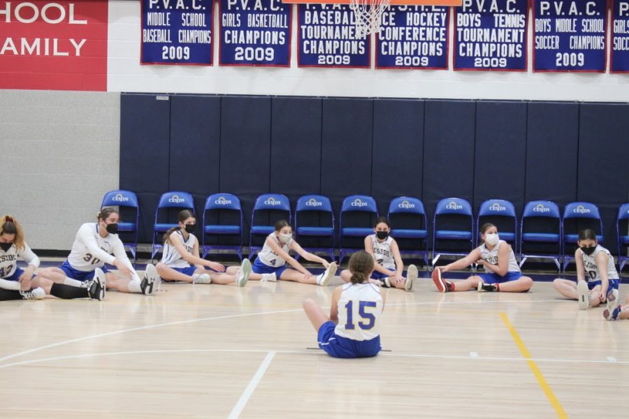 Lead by captain Gila Safra, the girls middle school basketball team begins their warm up with a few stretches to get out their nerves. “I am a little bit nervous because it’s our first home game, but I think it’s better that we have a lot of support here to cheer us on,” 7th grader Brielle Bassin said. “So far I think we’ve done pretty well and we’ve definitely gotten a lot better since the first start.” 