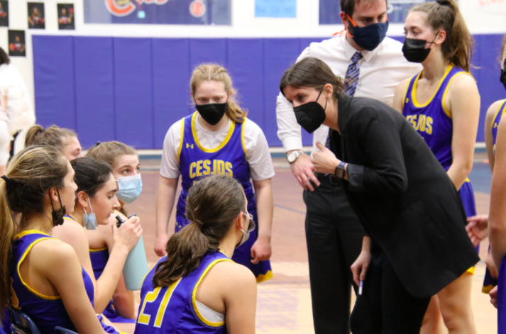 Head coach Becky Silberman talks to her players during a timeout. In basketball, timeouts are used to help players regroup, especially after getting scored on repeatedly. “Berman going up early was tough on us but we let up a storm and we played a hard game,” Cohen said.