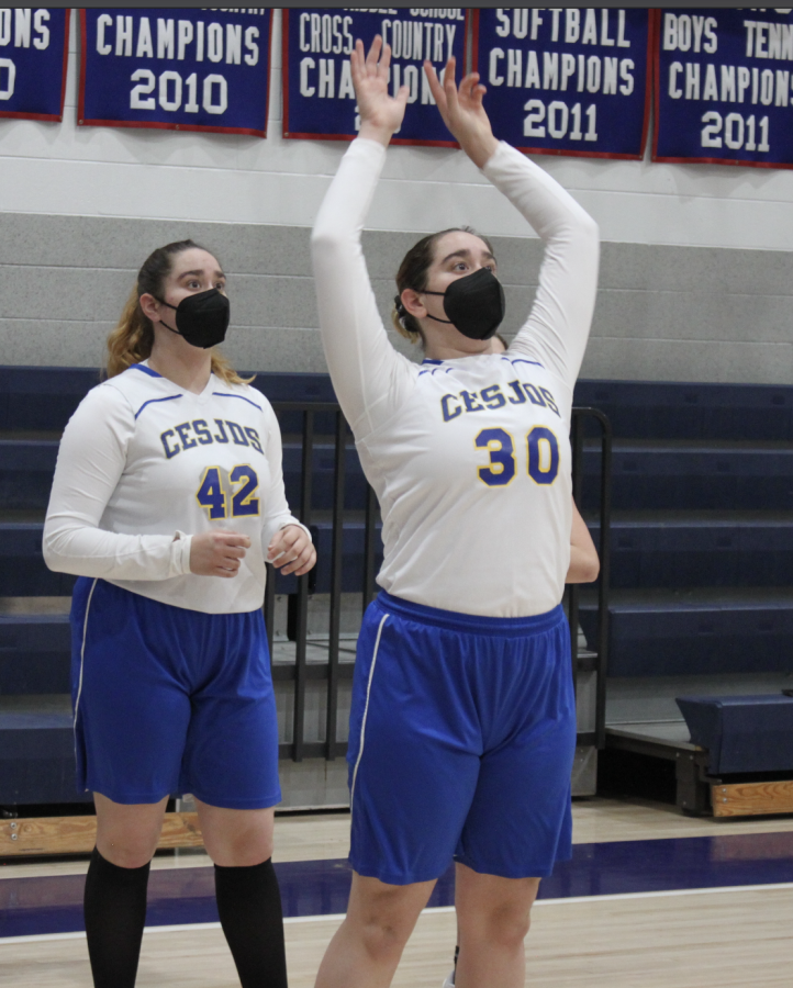 The twins participate in warm up drills prior to their middle school girls basketball game.