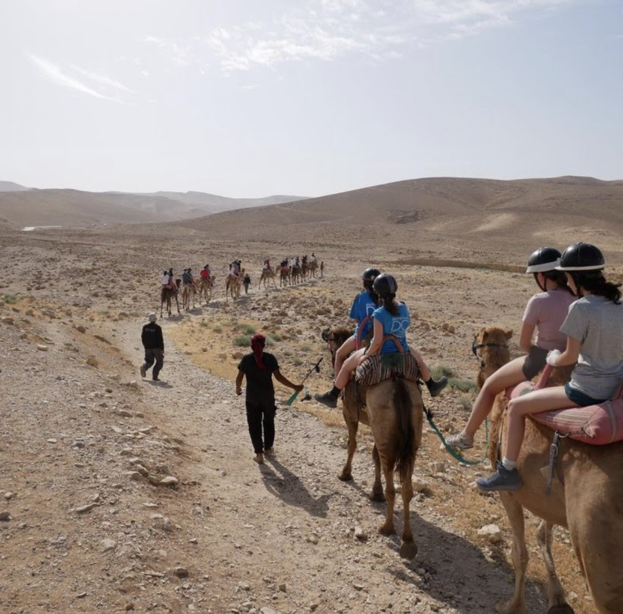 The Class of 2021 rides camels in Kfar Hanokdim in April 2021.