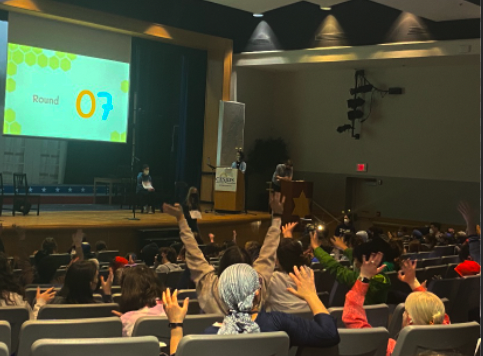 Students and faculty cheer on the participants of the 2022 middle school spelling bee, which was won by eighth-grader Malka Lederman.