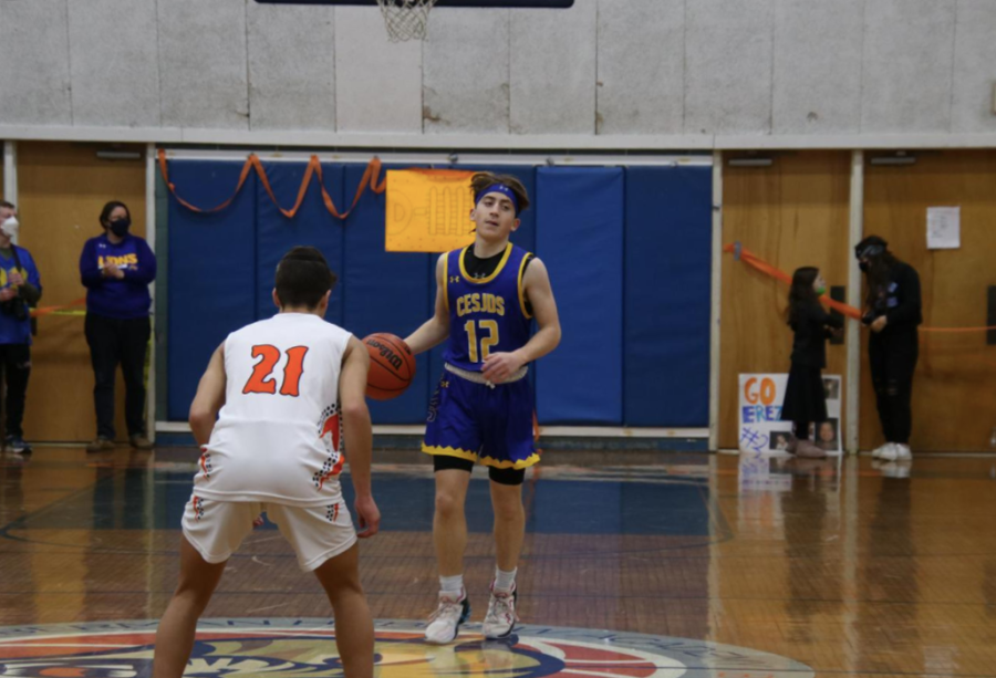Boys varsity basketball player Sam Sharp brings the ball down the court in a game against Melvin J. Berman Academy on Jan. 29, 2022. This was CESJDSs second game of the season against their rivals, which they won 48-41.  