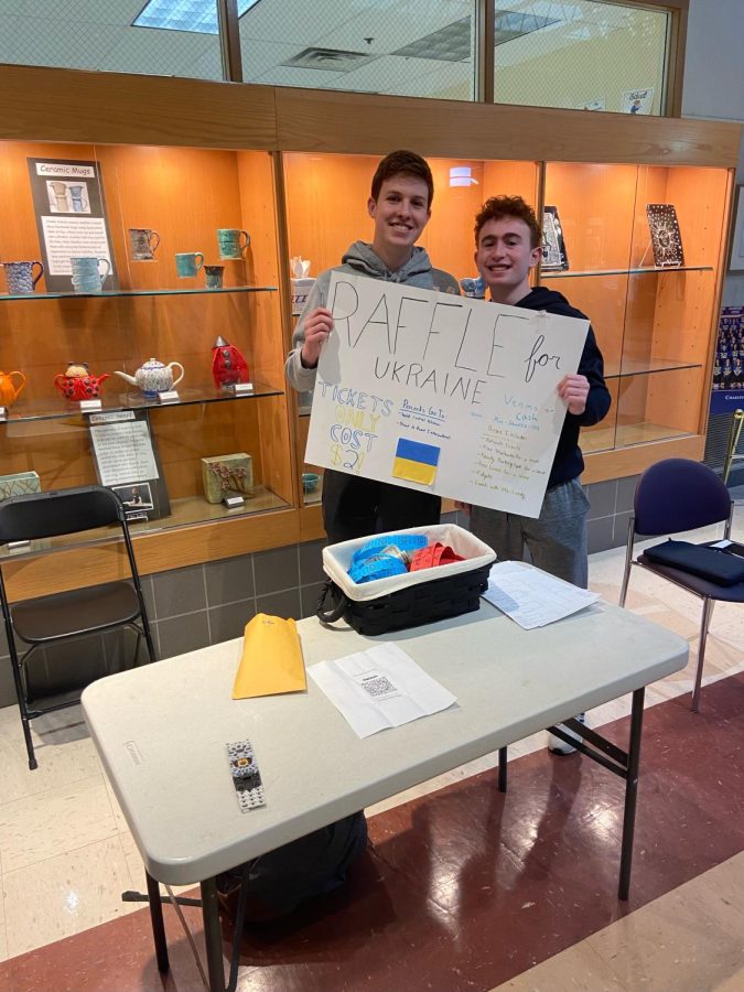 Juniors Max Schwartz and Harry Davidson selling raffle tickets at the front of the school to support Ukraine. 