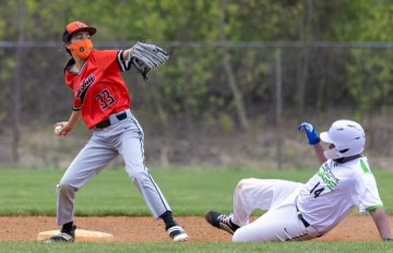 Freshman Shalvah Lazarus throws to first base during a travel game at Langley High School.