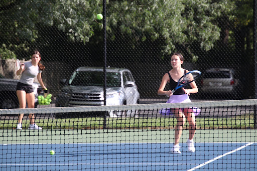 Freshman Maya Greenblum warms up during varsity girls tennis tryouts. The team won the PVAC conference last year, though they switched coaches since, and are now coached by new Health and Exercise Science Teacher Alex Kirsch.
