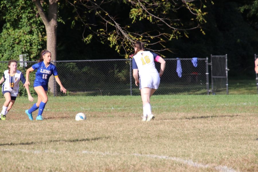 Junior Zoe Epstein dribbles through two defenders. The Lions went on to tie this game against The Field School in double overtime. 