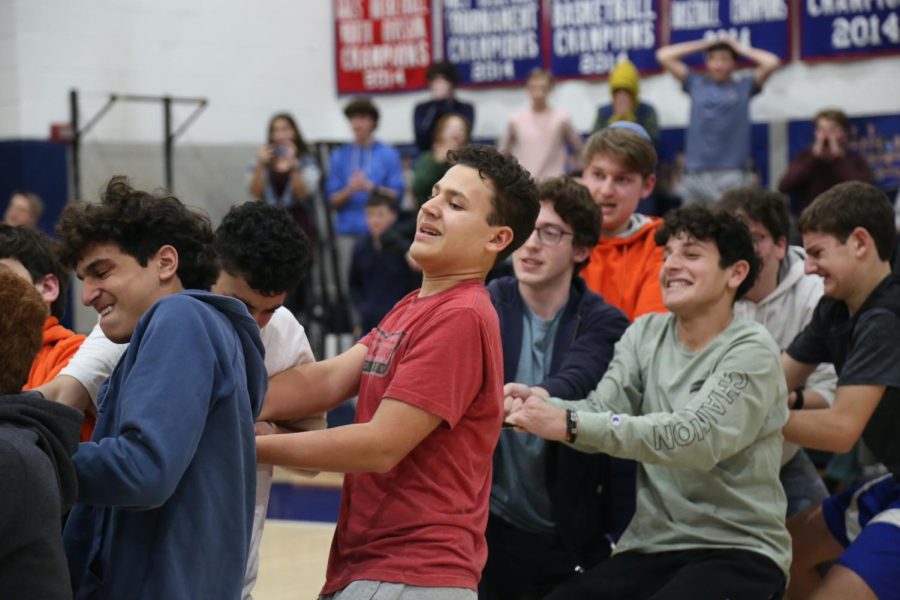 Juniors and sophomores  take on the seniors and freshmen in a cross-grade tug-of-war competition. After a minute of tugging, the juniors and sophomores pulled out the victory. 