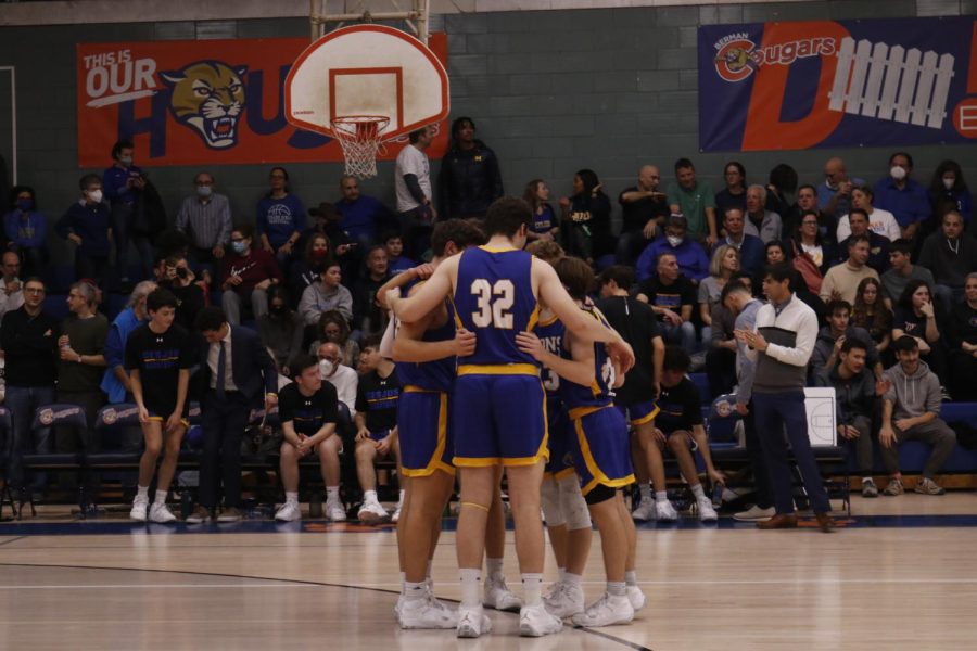 HUDDLE+UP%3A+The+starting+lineup+comes+together+to+go+over+their+game+plan+before+tipoff.+On+Saturday%2C+Dec.+17%2C+the+boys+varsity+basketball+team+played+against+their+rivals+Melvin+J.+Berman+Hebrew+Academy.+%E2%80%9CI+wasn%E2%80%99t+nervous+going+in+and+just+treated+it+like+any+other+game%2C%E2%80%9D+junior+Todd+Lazoff+said.+