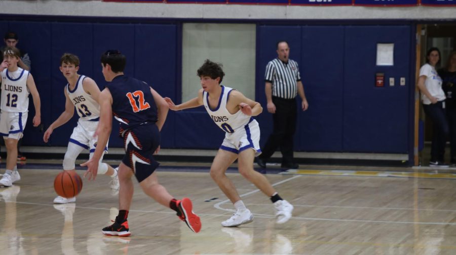 Junior Ari Blumenthal guards the ball in the Lions game against Berman on Jan. 19. 