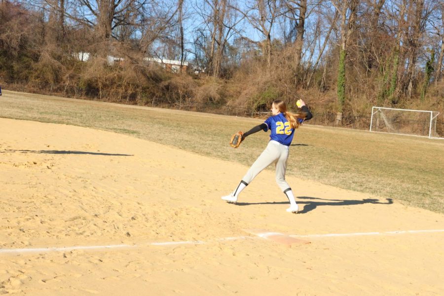 WARM-UP%3A+Freshman+Eliana+Wolf+warms+up+the+infield+by+throwing+ground+balls+to+her+teammates+before+the+game.+The+game+against+Stone+Ridge+was+the+season+opener+for+the+varsity+softball+team.