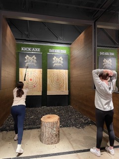 Freshmen Sophie Schwartz and Maiya Blumenthal practice their axe-throwing skills after learning the best techniques.