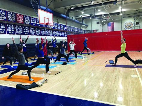 ESOL teacher Rebecca Reiser is leading the morning yoga session for a group of students. Yoga combines both healthy bodies and healthy minds, two aspects of the summit.
