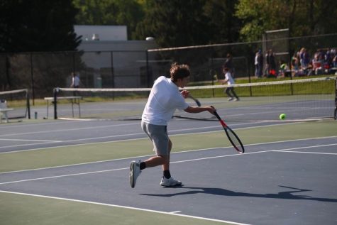 Freshman Coby Schlactus engages in a rally during his match against Berman.