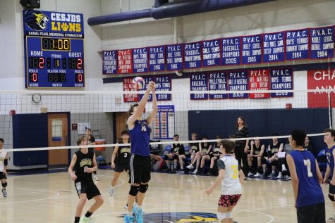 Sophomore Boaz Dauber scrambles to get the ball over the net and keep the point going. Photo By Gigi Gordon