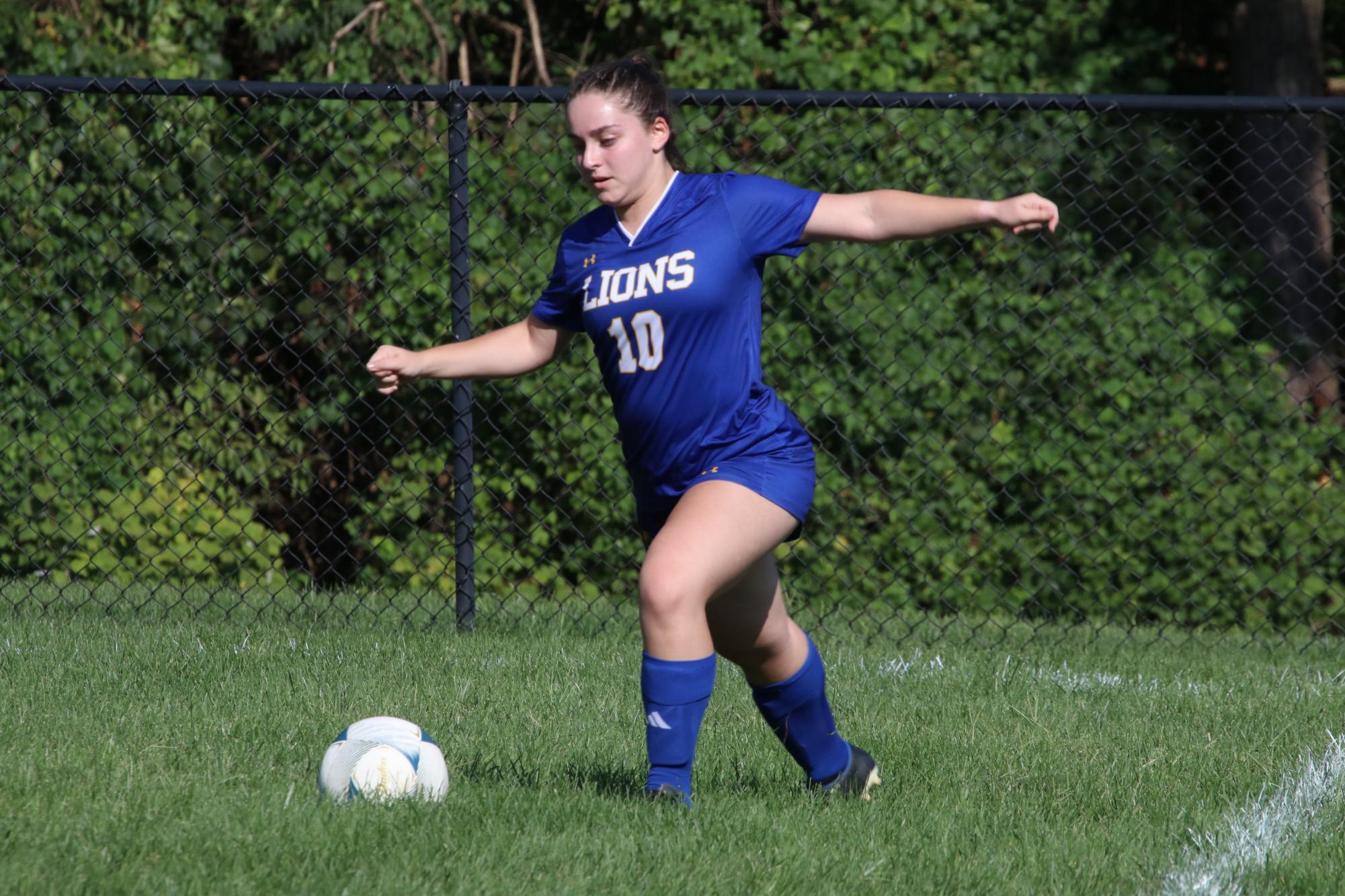 Senior Abby Greenberg has the ball for girls varsity soccer team. The team came back from a 2-1 deficit to tie the game.