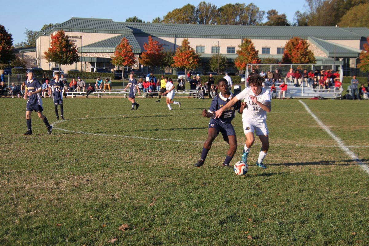 Senior Itai Topolosky fights for the ball with a defender. Topolosky went down with a concussion right before the half, but continued to support the team on the sideline.