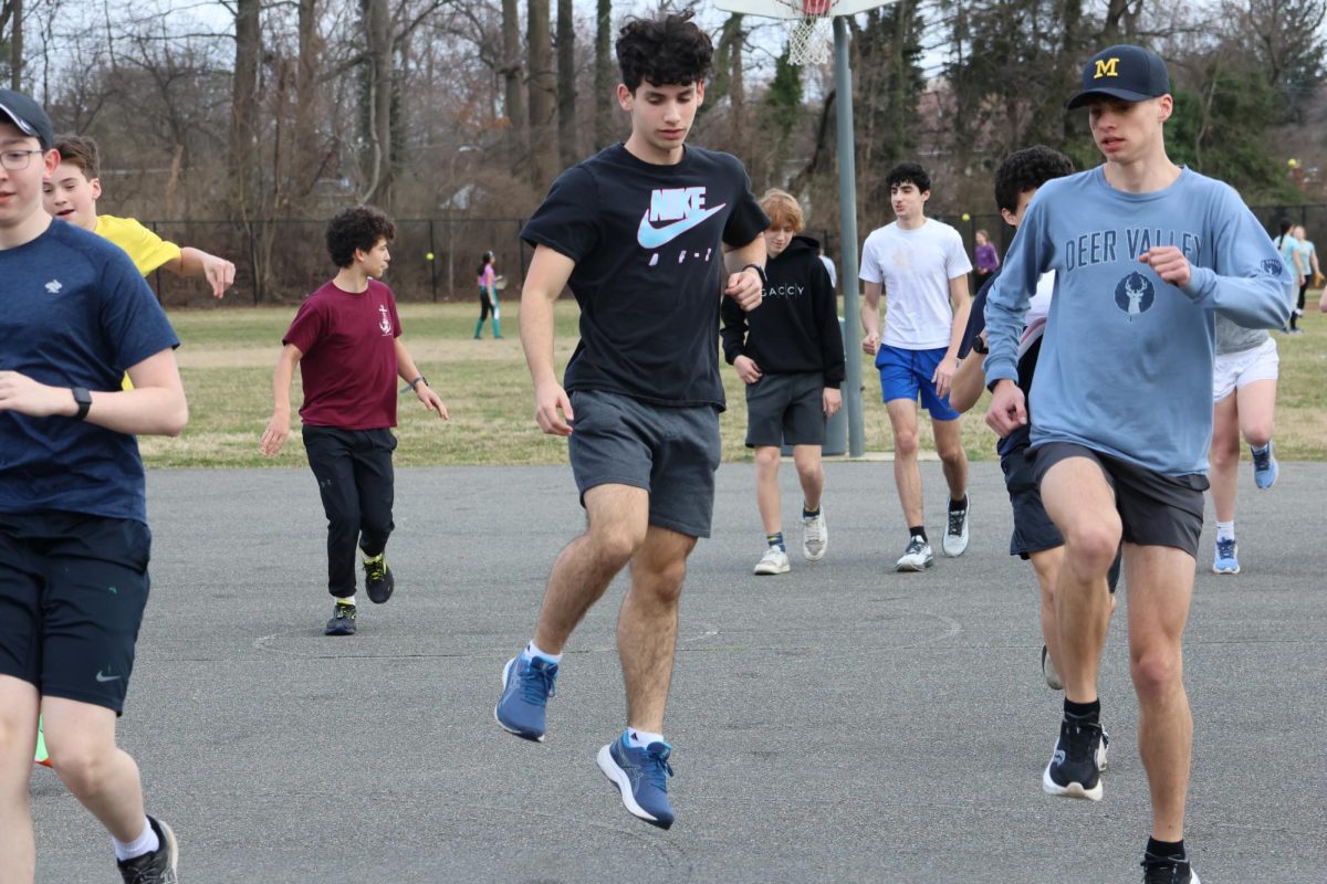 Spring sports tryouts lasted from March 4 until March 7, and included five teams. On the first day of tryouts, juniors Etai Evan (left) and Jonah Berman (right) warm up in preparation for a run during track tryouts. Berman has been running track since sixth grade and is looking forward to the upcoming spring season. He broke several personal records last season with a mile time of 4:56 minutes and an 800 meter time of 2:12 minutes. “I’m excited to try to break all my records and to get my personal best times,” Berman said.  