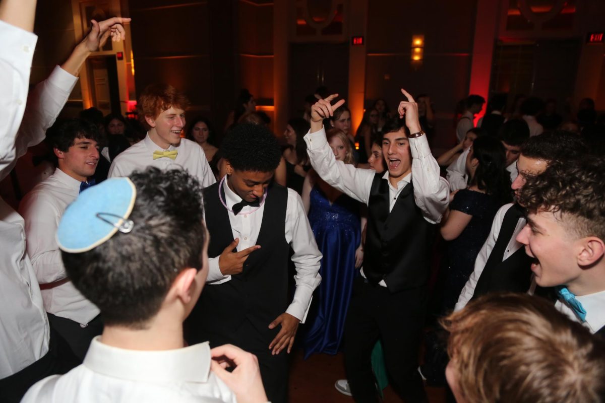 Senior Simon Reich spends his prom night encircled by his peers, dancing to the DJs music. 