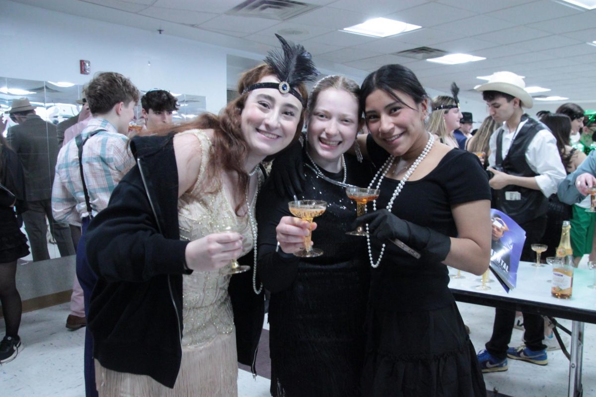 FLAPPER FASHION
Juniors Hannah Kaffee, Aliza Lesser and Shira Shapiro (left to right) enjoy glasses of sparkling apple cider at the Great Gatsby Day party, which was held in the cafeteria during advisory. Many students in the grade chose to wear flapper dresses to celebrate the event, including Kaffee, who got her dress from a senior. “The flapper dress is an iconic symbol of the 1920s,” Lesser said.