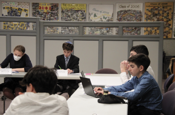 Seventh grade students represented countries in a mock United Nations climate summit. The representatives proposed solutions to climate change in small groups with a moderator. 