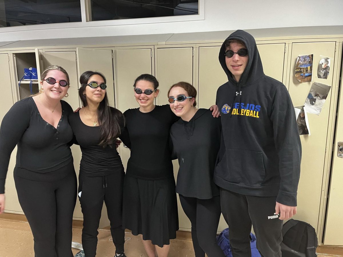 Members of the swim team wear googles the day of their swim meet. Photo used with permission from Stella Muzin.