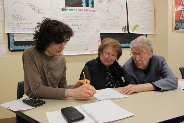 Sophomore Oliver Silver teaches his grandparents what hes been learning in math this year.