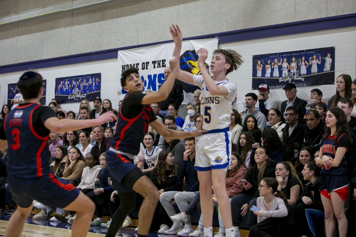 Sophomore Dylan Shank shoots from the corner during the Lions' game against Berman.