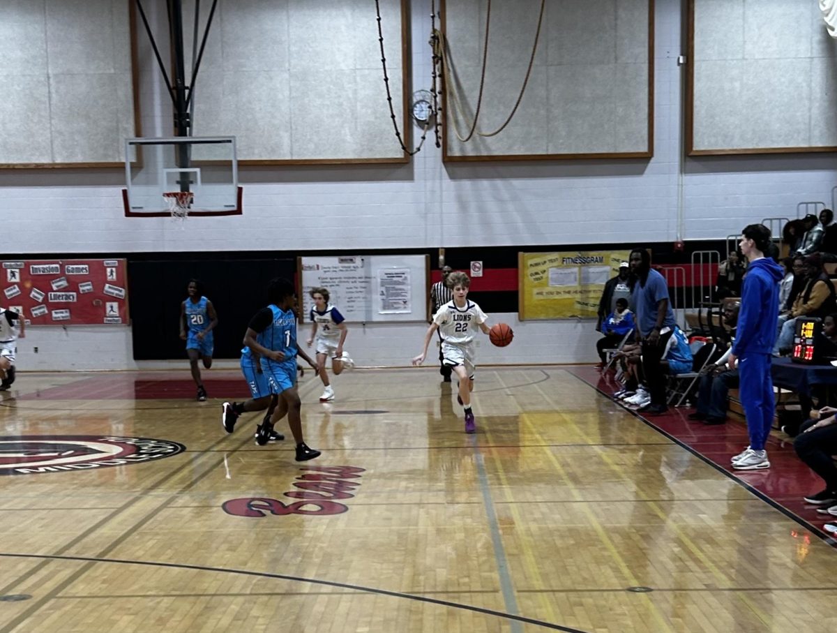 Eighth grade student Adam Nesher dribbles towards the basket at the SAA Middle School Winter Classic Basketball Tournament.