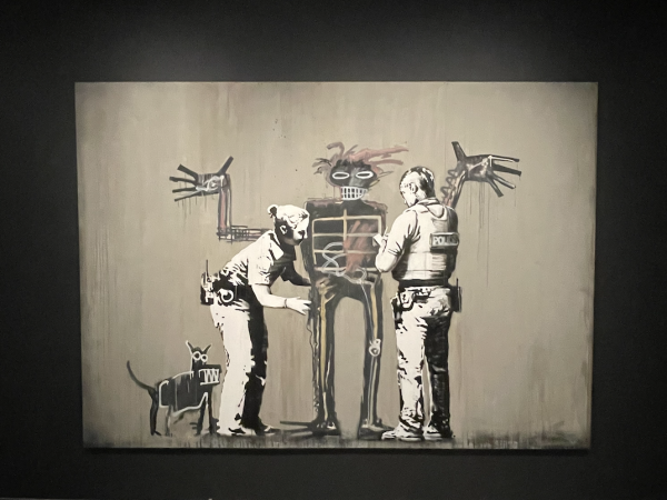 Bansky’s “Basquiat. Boy and dog in Stop and Search” touches on racial inequities faced by Black people in New York. 