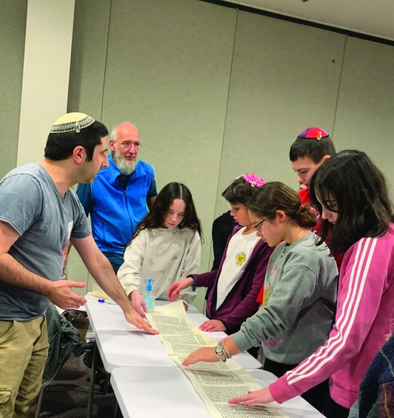 As part of a minimester seminar, a Torah scribe talks to students about the process of writing a Torah.