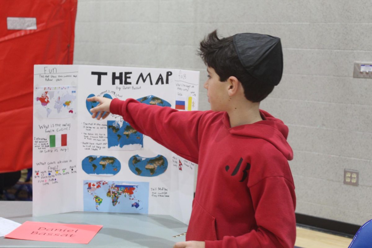 Middle school student presents his project to his peers on the final day of Minimester. 