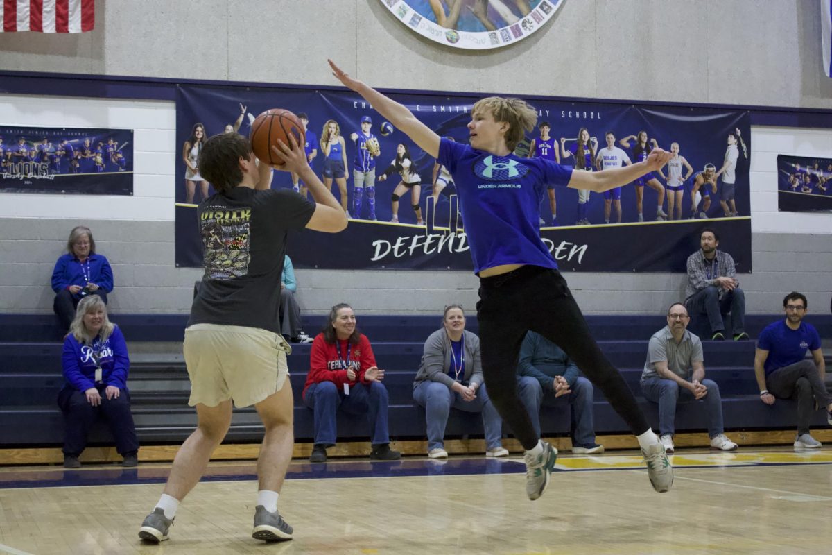 Sophomore Micah Brickman, a member of the Managers, blocks junior Jesse Fisher's shot in the tournament championship.