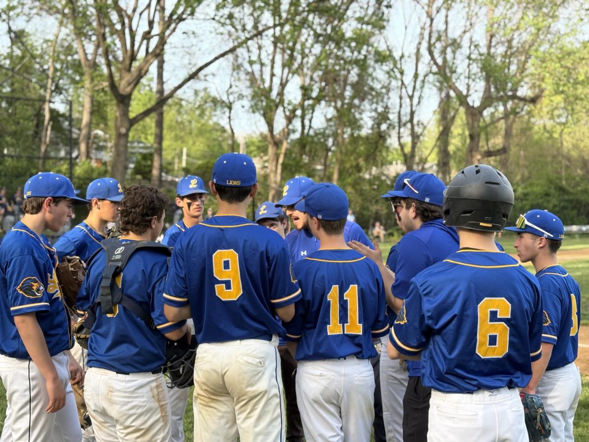 The Lions huddle up in between innings to discuss strategies for play.