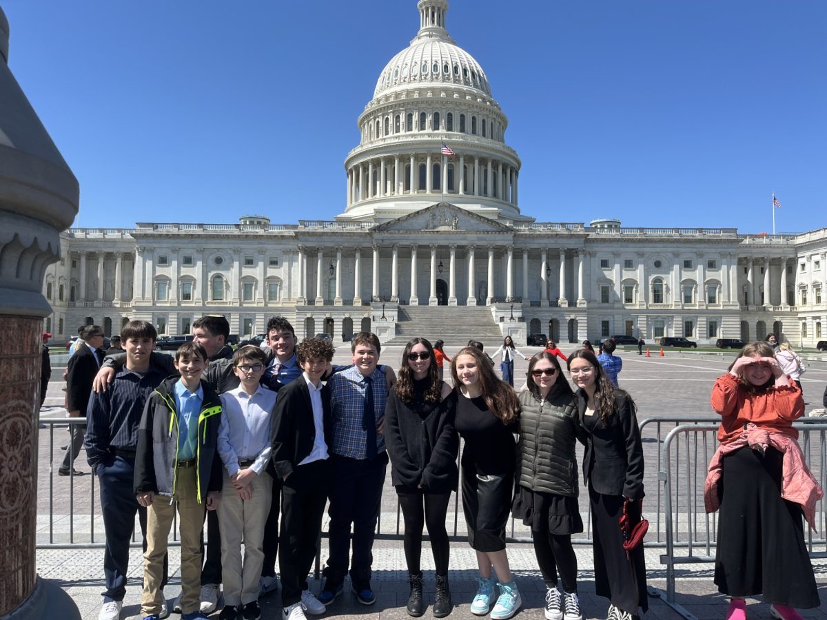 Eighth grade students pose outside the Capitol, where they connected their government class to real life. 