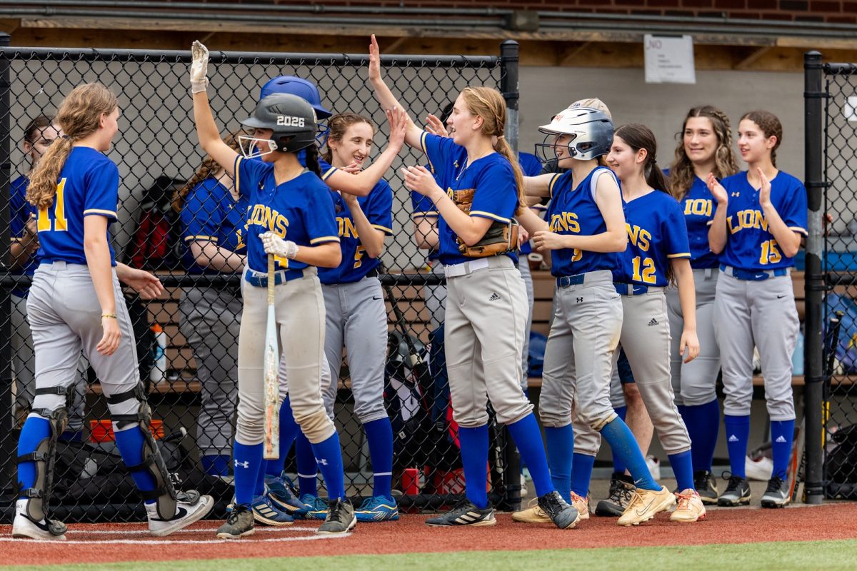 Varsity softball team prepares for their turn at bat during their championship game.