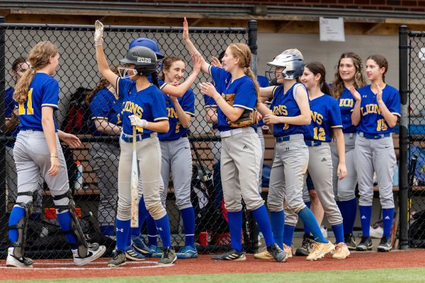 Varsity softball team prepares for their turn at bat during their championship game.