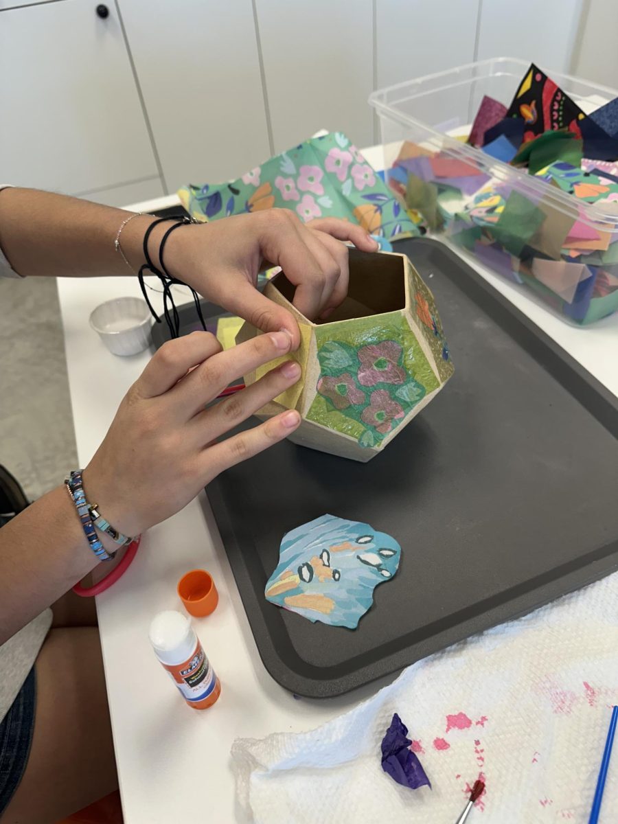 One of the arts and craft projects available at District DabbleLab is decorating a papier mache vase.