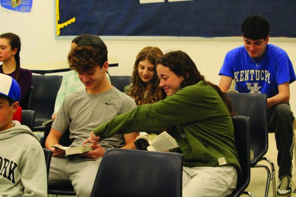 Sophomore Leora Blumenthal helps seventh grade student Riley Blay find
his place in the siddur. 