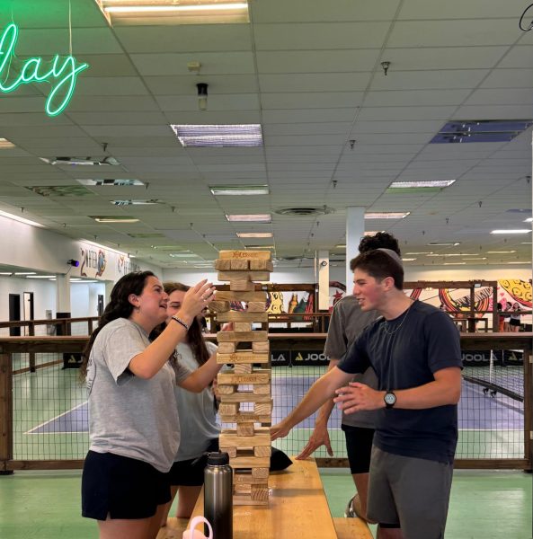 Seniors Ami Epstein and Liem Elgrably build a jenga tower on their field trip to Kraken Kourts. 