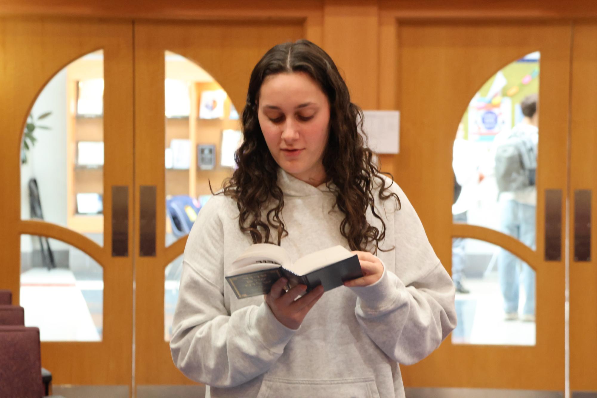 Sophomore Kira Koplow davens in the Beit Midrash. 
