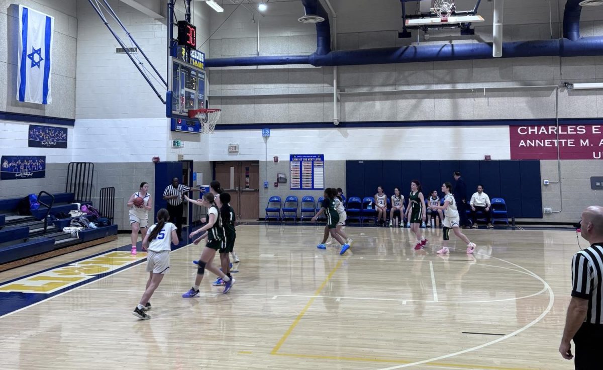 Eighth-grader Liza Cutler passes the ball from the baseline.