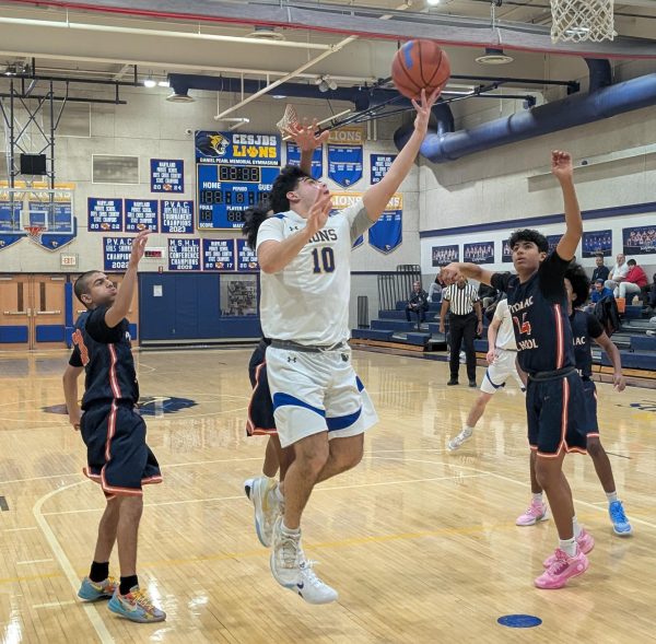 Sophomore Hillel Goldberg attempts a contested layup against the Potomac School Panthers