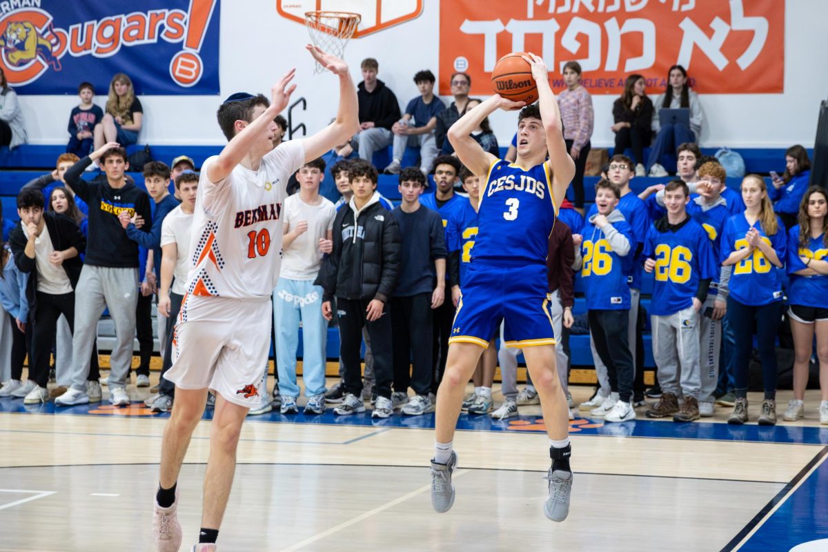 Senior Micah Goldrich rises up to launch a mid-range jumper over sophomore Berman defender Yaakov Lesnoy.