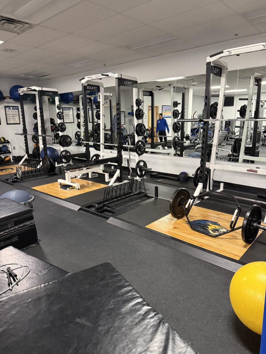 The training room is equipped with both machines and free-weights