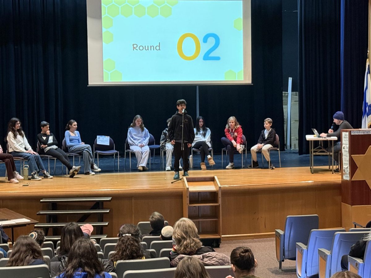 8th grade student Benjamin Selzer spells the correct word and advances on to the next round.