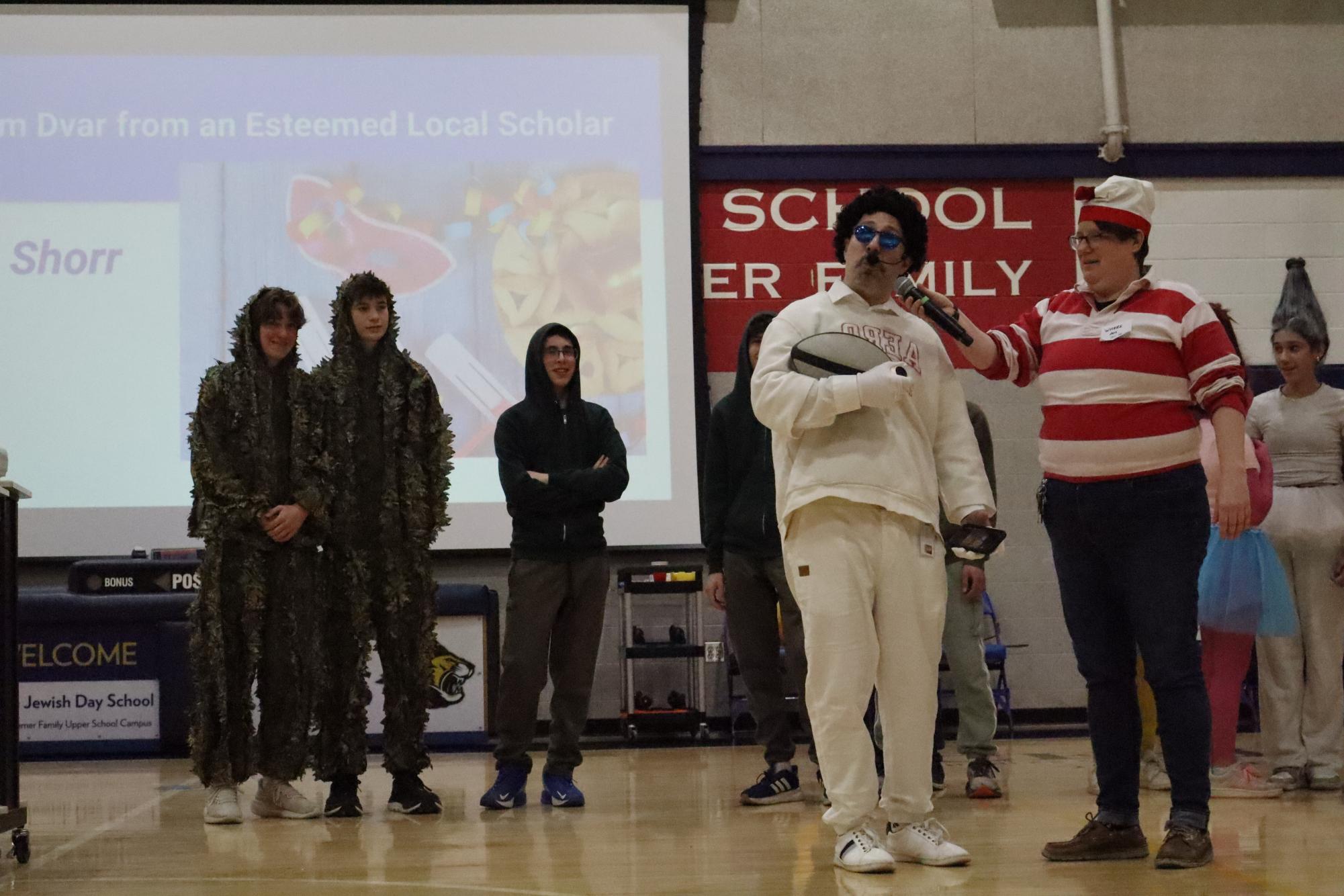 High school learning specialist Brett Kugler presents his group's costume.