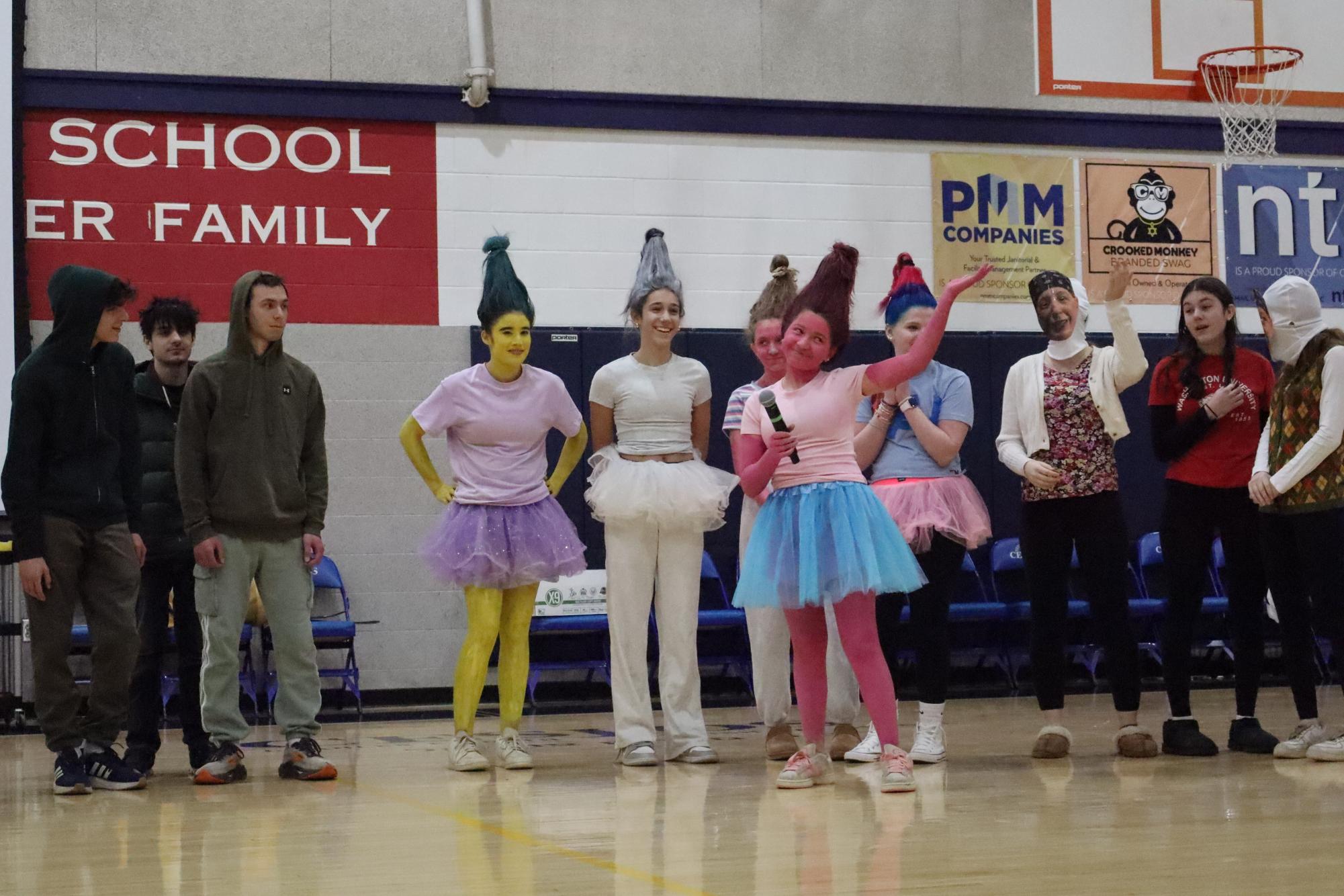 Mae Stein presents the group's trolls costume at the Purim assembly.